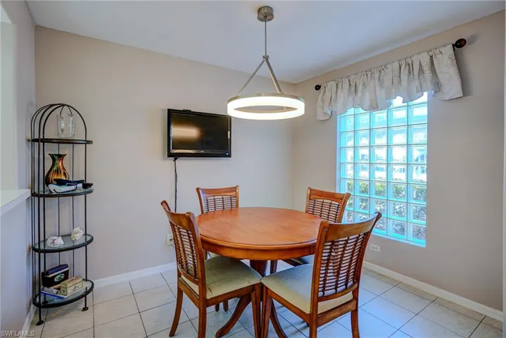Dining room with baseboards, a healthy amount of sunlight, and light tile patterned floors