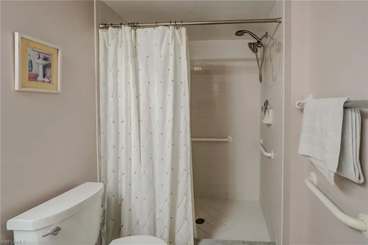 Full bath with a shower stall and toilet