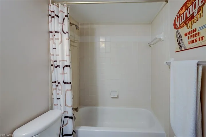 Bathroom featuring toilet and shower / bath combo