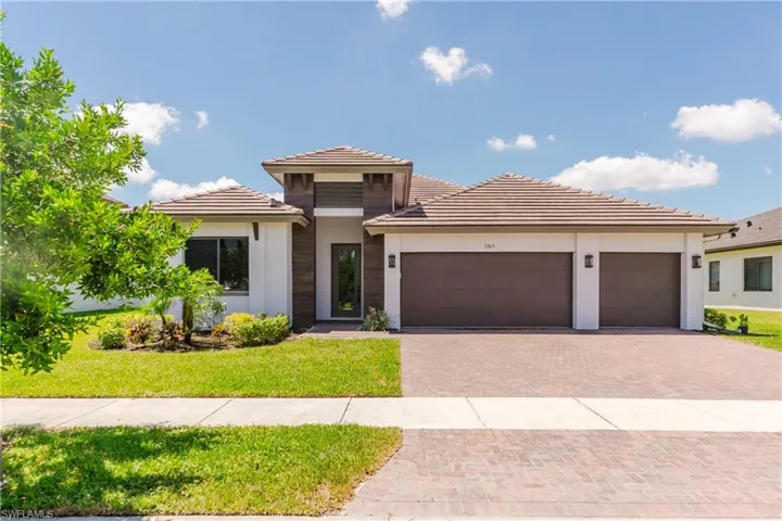 Contemporary single-story residence with a tile roof and a two-car garage