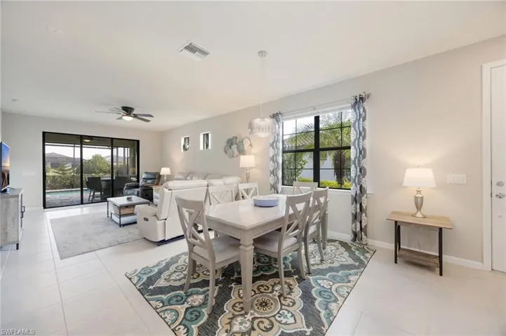 Living room featuring light tile patterned floors and ceiling fan