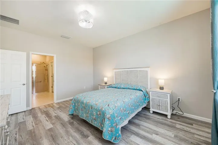 Full bath featuring double vanity, a stall shower, and light tile patterned flooring