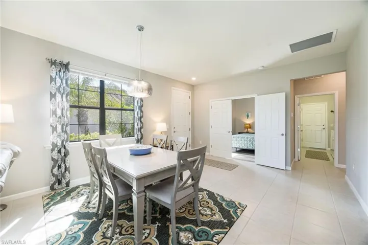 View of patio featuring outdoor dining space, a sunroom, a ceiling fan, glass enclosure, and an outdoor pool
