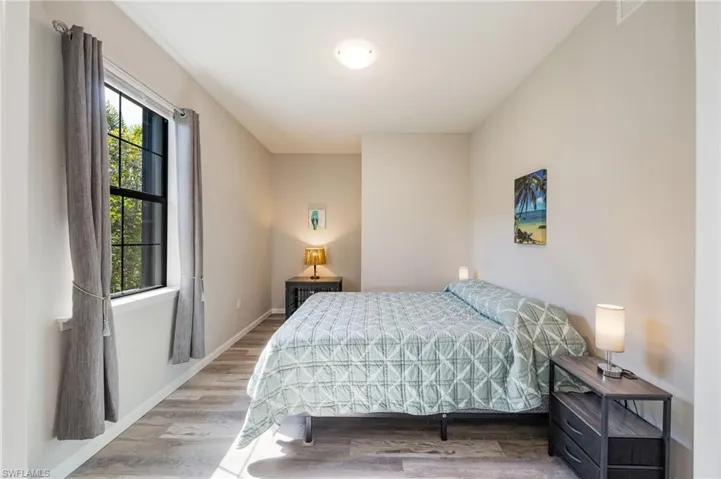 Laundry area with independent washer and dryer and light tile patterned flooring