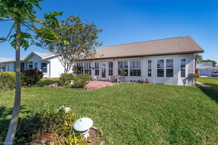 Back of house featuring a yard and a patio area