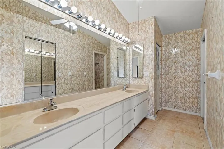 Bathroom featuring tile patterned flooring and vanity