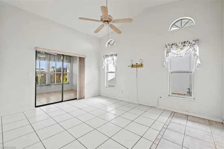 bedroom with light tile patterned flooring, ceiling fan, and vaulted ceiling