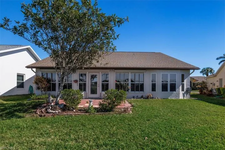 Back of house featuring a patio and a lawn