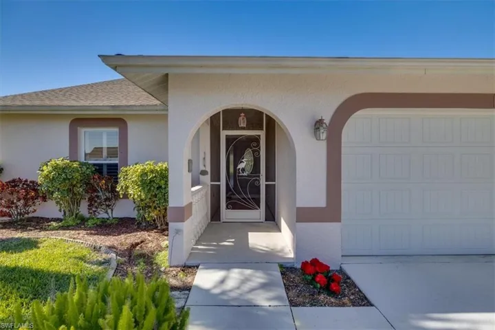 Doorway to property with a garage