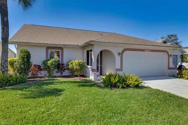 Ranch-style home featuring a garage and a front yard