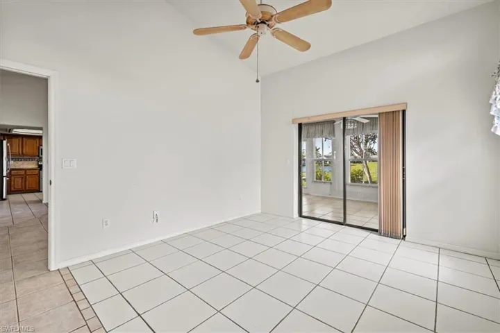 bedroom featuring high vaulted ceiling, light tile patterned floors, and ceiling fan