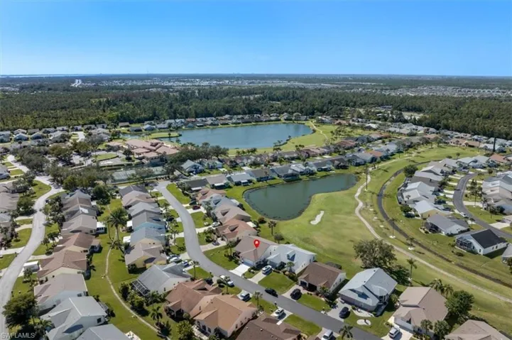 Birds eye view of property with a water view