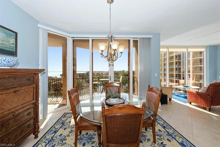 Dining area featuring suspended lighting and light tile patterned floors
