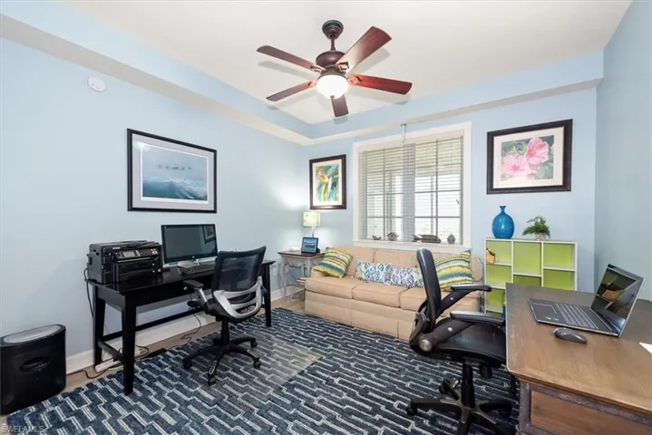 Office area featuring ceiling fan and wood finished floors