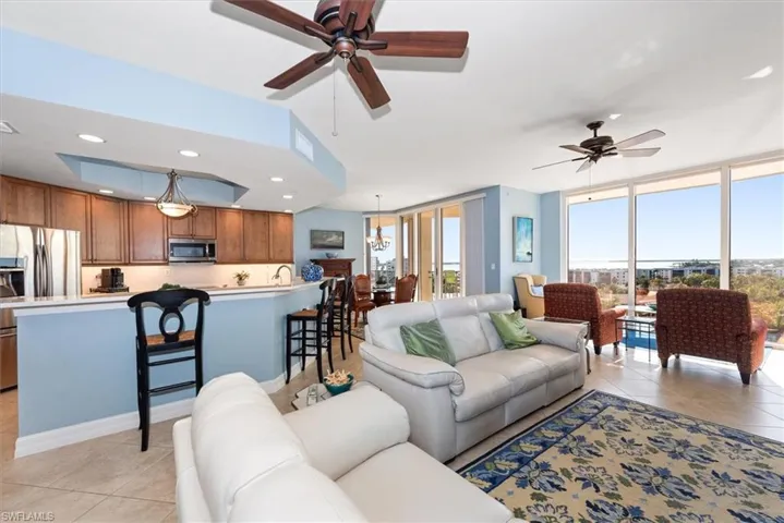 Living area featuring light tile patterned floors, a ceiling fan, recessed lighting, and floor to ceiling windows