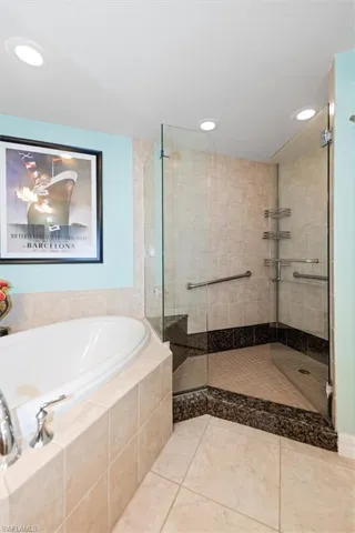 Full bath featuring a shower stall, a bath, tile patterned flooring, and recessed lighting