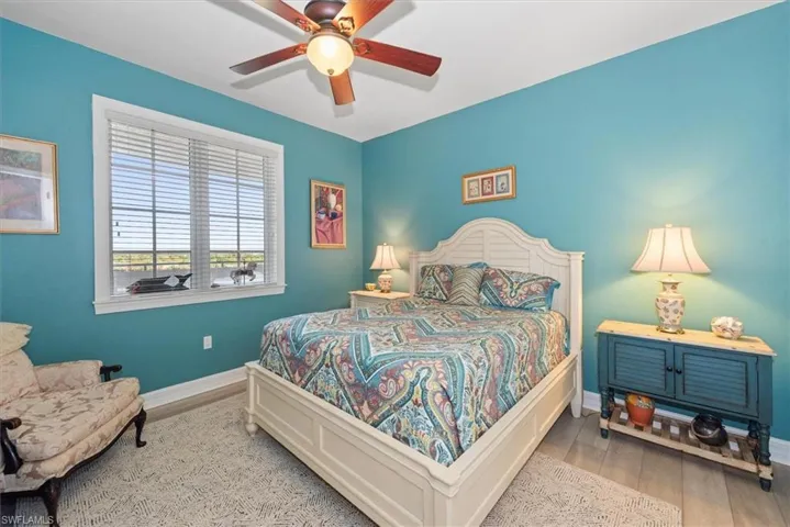 Bedroom featuring wood finished floors and a ceiling fan