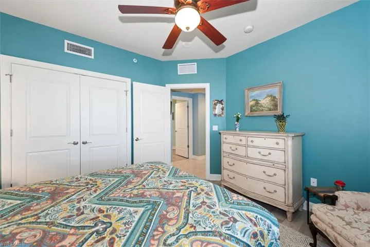 Bedroom featuring a ceiling fan and a closet