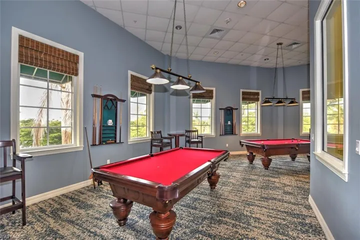 Recreation room featuring billiards table, a paneled ceiling, and plenty of natural light