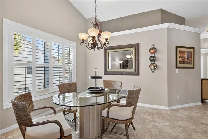 Dining room with a chandelier and light tile patterned floors