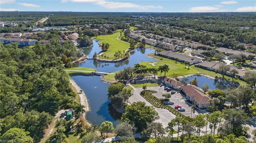 View of property location featuring a golf course and nearby suburban area