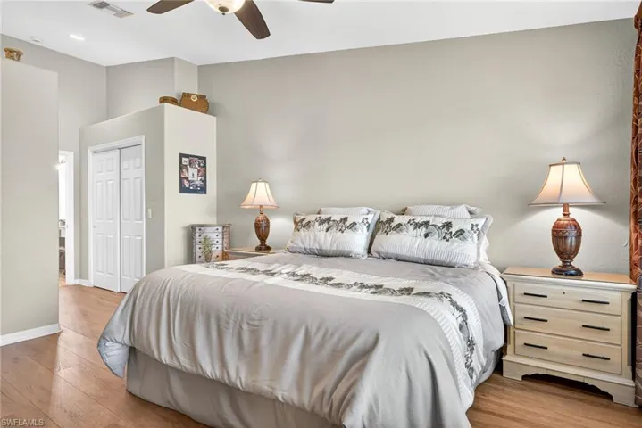 Bedroom featuring light wood-style floors, a closet, and ceiling fan