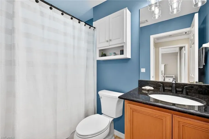 Full bath featuring a shower with curtain and vanity