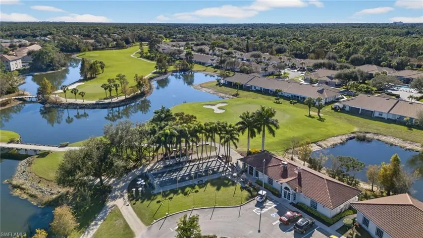Aerial view of residential area with a large body of water and a local golf course
