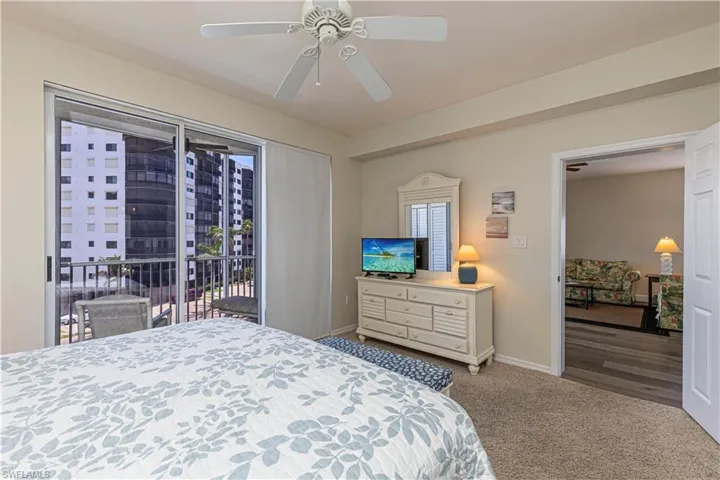 Bedroom featuring baseboards, carpet flooring, access to outside, and ceiling fan