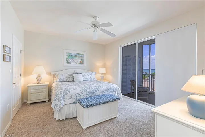 Bedroom featuring light colored carpet, access to outside, baseboards, and ceiling fan