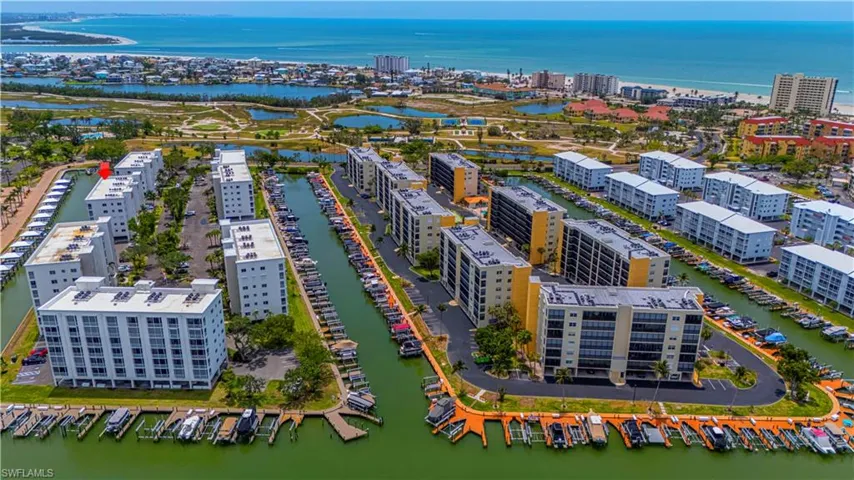 Birds eye view of property featuring a water view and a view of city