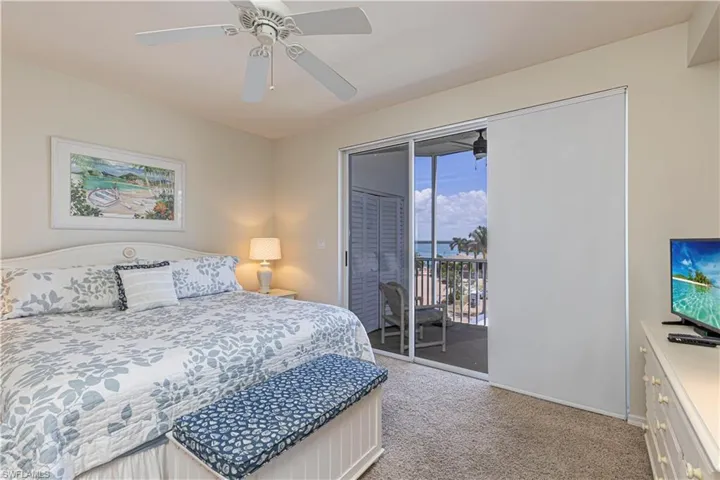 Bedroom with carpet, access to outside, baseboards, and ceiling fan