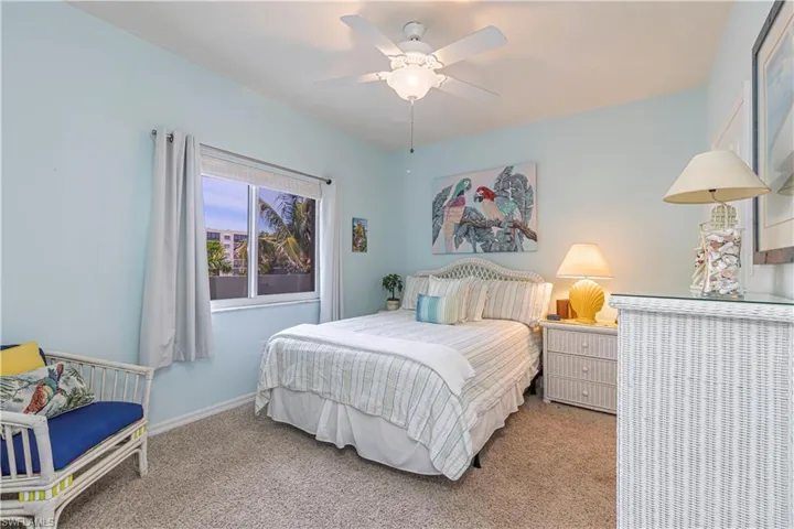 Bedroom featuring ceiling fan and carpet flooring