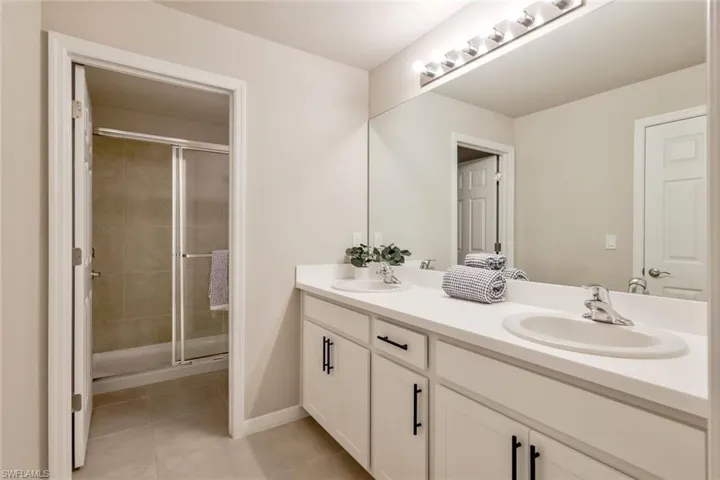 The primary bath features a shower and dual sinks with oversized vanity.