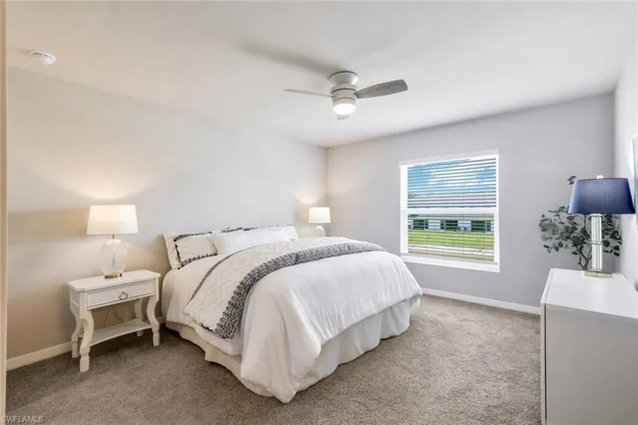 Spacious primary suite with 2 walk in closets and in suite bath.