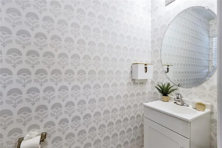 Guest bath with updated vanity and Serena & Lily wallpaper.