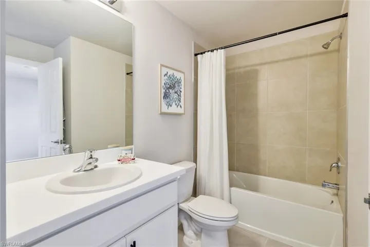 Full bathroom featuring shower / tub combo and  linen closet.
