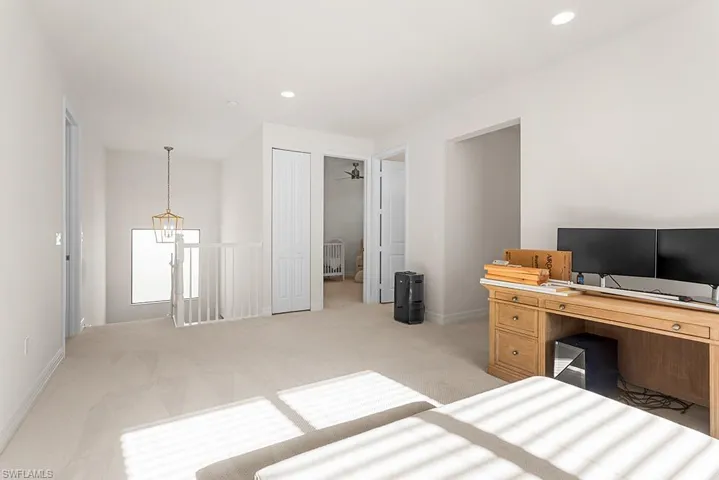 Carpeted bedroom with a closet