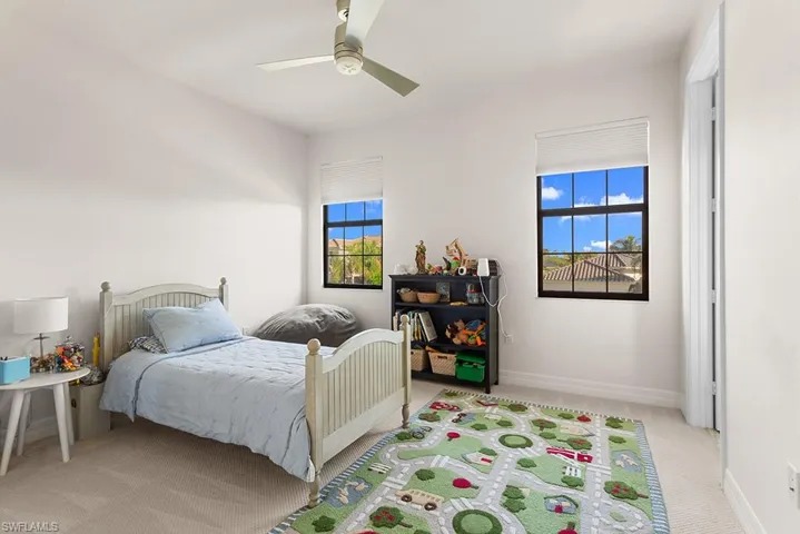 Carpeted bedroom with ceiling fan