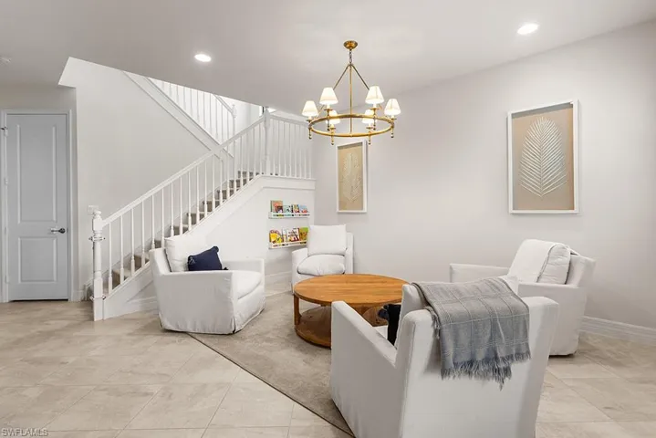 Living room featuring a notable chandelier and light tile patterned floors