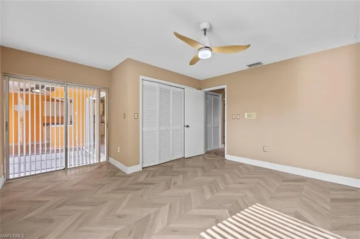 Guest bedroom 1 has sliders leading to the bonus room