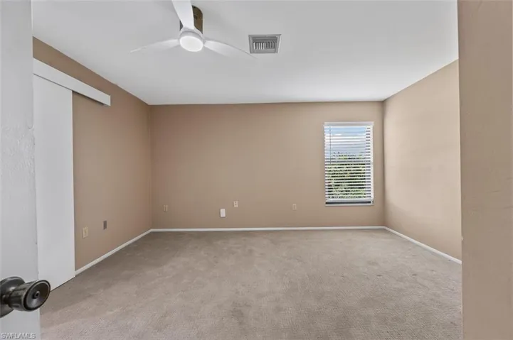 Primary bedroom is nice and large with carpeted flooring