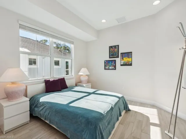 Bedroom with light  wood-style flooring