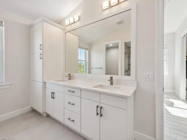 Bathroom with vanity and lofted ceiling