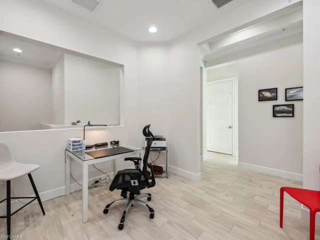 Office area with light wood-type flooring