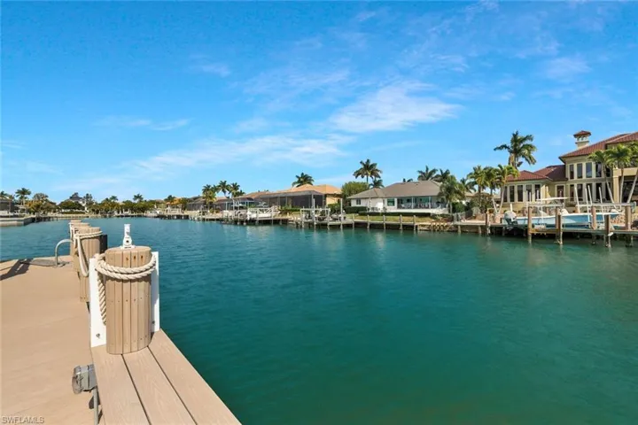 Dock area with a residential view and a water view