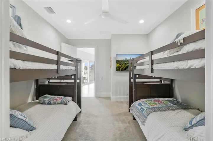 Bedroom with light colored carpet, ornamental molding, a ceiling fan, and recessed lighting