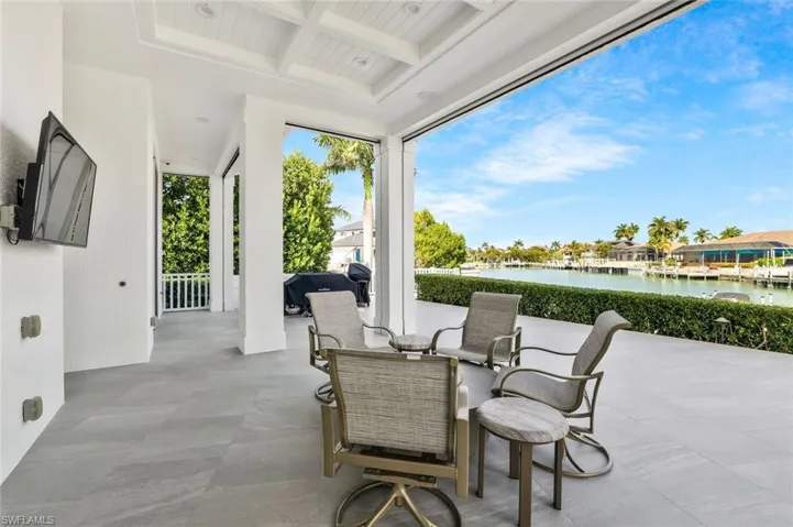 View of patio with a water view and outdoor dining space
