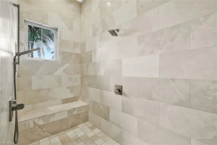 Full bath featuring tiled shower