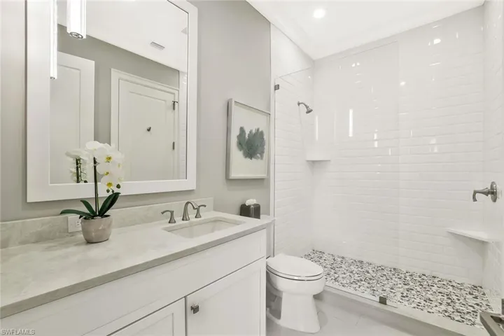 Full bath with vanity, a stall shower, and recessed lighting